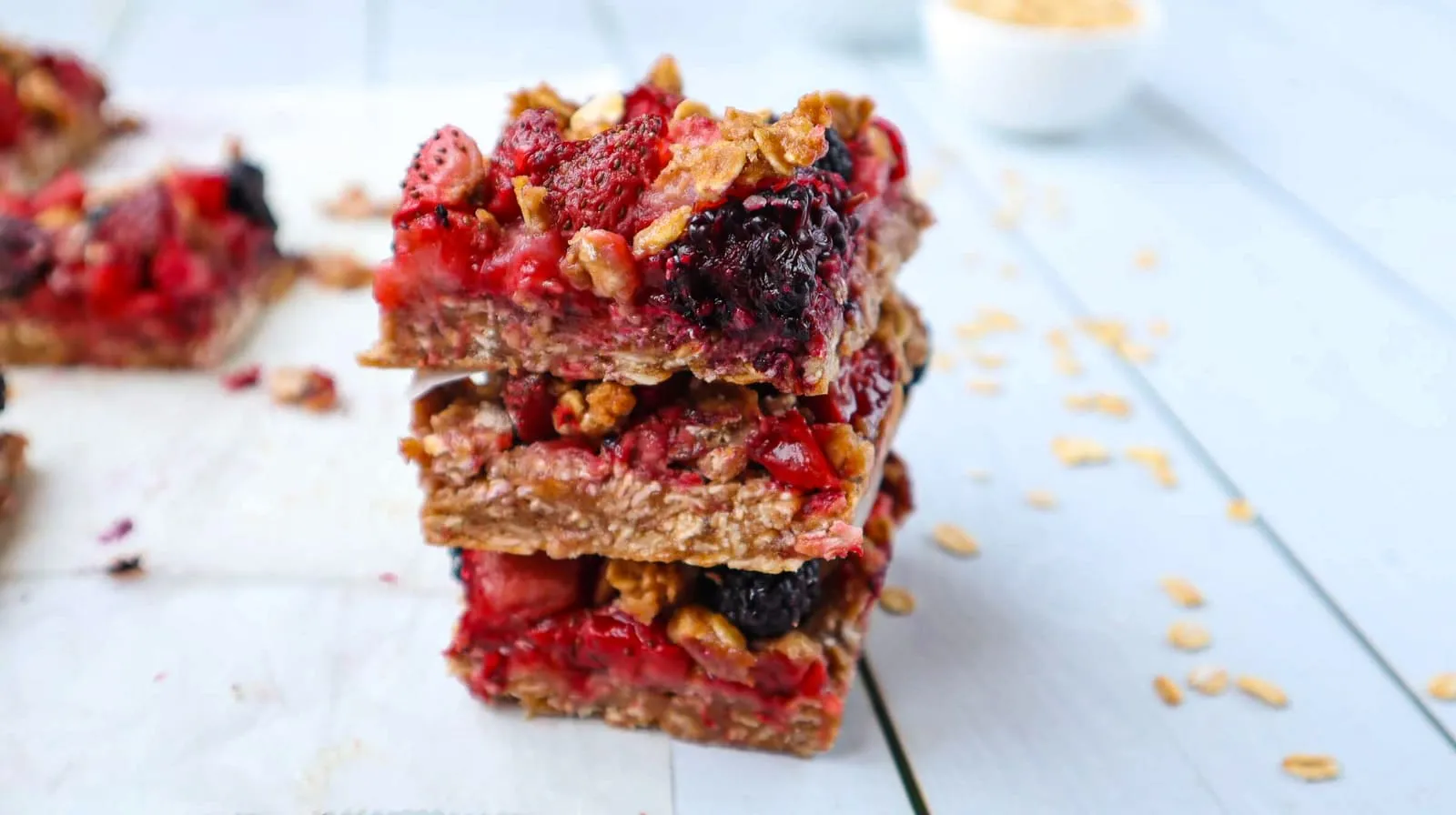 Storing strawberry oat bars: cut parchment paper into squares of the same size, put one between each bar, and pack them in an airtight zip-top bag.